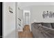 Hallway view with hardwood flooring and stairs leading to upper level, adjoined to a comfortable living area at 414 Fallingbrook Dr, Kenly, NC 27542