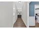 Bright hallway with hardwood floors, neutral walls, and doorway views of the living spaces at 414 Fallingbrook Dr, Kenly, NC 27542