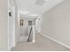 Well-lit hallway with neutral paint and carpet at 414 Fallingbrook Dr, Kenly, NC 27542