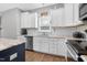 Bright kitchen featuring white cabinetry, granite countertops, subway tile backsplash, and stainless steel appliances at 414 Fallingbrook Dr, Kenly, NC 27542