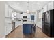 Expansive kitchen with stainless appliances, marble counters, white cabinets, and a blue island with seating at 414 Fallingbrook Dr, Kenly, NC 27542