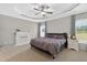 Relaxing main bedroom with trey ceiling, neutral tones, and large windows for natural light at 414 Fallingbrook Dr, Kenly, NC 27542