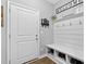 Clean mudroom with storage bench and hooks for organization near the front door, showcasing practical home design at 414 Fallingbrook Dr, Kenly, NC 27542
