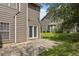 A view of the back of the home featuring a concrete patio, green lawn, and double glass doors at 4406 Still Pines Dr, Raleigh, NC 27613