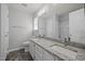 Well-lit bathroom features a double vanity, granite countertop, and a shower-tub combo at 4406 Still Pines Dr, Raleigh, NC 27613