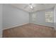 A bedroom with a ceiling fan and two windows at 4406 Still Pines Dr, Raleigh, NC 27613