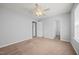 Spacious bedroom with a ceiling fan, neutral walls, and plush carpeting at 4406 Still Pines Dr, Raleigh, NC 27613