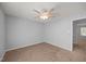 Carpeted bedroom featuring a ceiling fan and a connecting door at 4406 Still Pines Dr, Raleigh, NC 27613