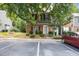 Inviting townhome featuring a well-maintained lawn, brick facade, and convenient parking in front at 4406 Still Pines Dr, Raleigh, NC 27613
