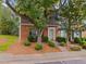 Charming townhome with brick and gray siding, complemented by lush landscaping and a welcoming entrance at 4406 Still Pines Dr, Raleigh, NC 27613