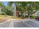 Attractive townhome showcasing a brick and siding exterior, enhanced by mature trees and manicured greenery at 4406 Still Pines Dr, Raleigh, NC 27613