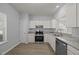 Bright kitchen with white cabinets, granite counters, and stainless steel appliances at 4406 Still Pines Dr, Raleigh, NC 27613