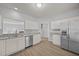 Open kitchen showcases stainless steel appliances, granite counters, and wood flooring at 4406 Still Pines Dr, Raleigh, NC 27613