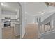 Open-concept living room, with stairs to the second floor, leading into kitchen and dining area at 4406 Still Pines Dr, Raleigh, NC 27613