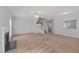 Living room with plush carpeting, a ceiling fan, a staircase, and a fireplace at 4406 Still Pines Dr, Raleigh, NC 27613
