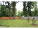 Spacious backyard featuring mature trees and a privacy fence at 4511 Denfield St, Durham, NC 27704