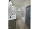 Bathroom with double vanity, quartz countertops, a walk-in shower and modern fixtures at 4511 Denfield St, Durham, NC 27704