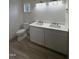Well-lit bathroom with double vanity sinks, white cabinets, and a toilet, for comfort and convenience at 4511 Denfield St, Durham, NC 27704