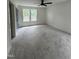 Bright bedroom featuring neutral carpet and large windows with a view of the surrounding landscape at 4511 Denfield St, Durham, NC 27704
