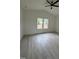 Bedroom with new flooring, white walls, a ceiling fan and plenty of natural light at 4511 Denfield St, Durham, NC 27704