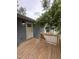 Back porch detail with wood deck and stairs leading to back door at 4511 Denfield St, Durham, NC 27704