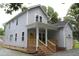 Two-story home featuring a welcoming front porch with steps and an attached garage at 4511 Denfield St, Durham, NC 27704