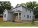 Two-story home boasts a charming front porch and well-maintained exterior at 4511 Denfield St, Durham, NC 27704