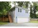 Detached garage with finished room above and wooden stair access at 4511 Denfield St, Durham, NC 27704