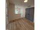Bright hallway with wood floors and a modern light fixture, connecting the living spaces at 4511 Denfield St, Durham, NC 27704