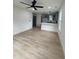 Bright living room featuring light wood floors, ceiling fan, and open access to the contemporary kitchen at 4511 Denfield St, Durham, NC 27704