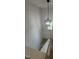 Modern staircase features a stylish chandelier and ample natural light, adding elegance to the entryway at 4511 Denfield St, Durham, NC 27704