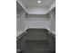 Spacious walk-in closet features built-in shelving and rod system for optimal organization at 4511 Denfield St, Durham, NC 27704