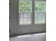 Bright bedroom with double hung windows that let in plenty of natural light and offer a scenic view at 4511 Denfield St, Durham, NC 27704