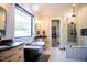 Stunning bathroom features a freestanding tub, walk-in shower, and modern tile at 46 Lakes Edge Ln, Pittsboro, NC 27312