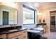 The main bath showcases dual vanities, a garden tub, and lots of natural light at 46 Lakes Edge Ln, Pittsboro, NC 27312
