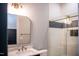 Modern bathroom featuring marble countertop, gold fixtures, and a glass-enclosed shower with decorative tiling at 46 Lakes Edge Ln, Pittsboro, NC 27312