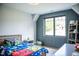 Bright bedroom boasts natural light from a large window and playful Mario-themed bedding at 46 Lakes Edge Ln, Pittsboro, NC 27312