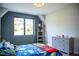 Comfortable bedroom featuring a large window, grey dresser, and colorful Mario-themed bedding at 46 Lakes Edge Ln, Pittsboro, NC 27312