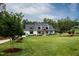 Stunning modern farmhouse with a well-manicured lawn and inviting front porch at 46 Lakes Edge Ln, Pittsboro, NC 27312