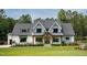 Charming two-story home with a combination of white siding, grey shingles and professionally landscaped front yard at 46 Lakes Edge Ln, Pittsboro, NC 27312