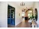 Spacious foyer featuring hardwood floors, shiplap walls, modern lighting fixtures, and an open view to the living room at 46 Lakes Edge Ln, Pittsboro, NC 27312