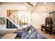 Open-concept living room with hardwood floors, comfortable seating, staircase, dining area, and inviting foyer at 46 Lakes Edge Ln, Pittsboro, NC 27312