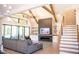 Bright and airy living room with vaulted ceilings, wooden beams, modern fireplace and large windows with outdoor view at 46 Lakes Edge Ln, Pittsboro, NC 27312