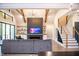 Stylish living room showcasing a modern fireplace, wooden beams, staircase with metal railings, and open floor plan at 46 Lakes Edge Ln, Pittsboro, NC 27312