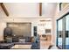 Open-concept living room, dining, and kitchen area featuring vaulted ceilings, hardwood floors, and modern decor at 46 Lakes Edge Ln, Pittsboro, NC 27312