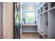 Well-organized mudroom with custom storage cubbies, bench, and open window for natural light at 46 Lakes Edge Ln, Pittsboro, NC 27312