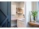 Charming mudroom area with a workstation, white cabinets and sink featuring stylish backsplash at 46 Lakes Edge Ln, Pittsboro, NC 27312