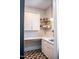 Convenient mudroom area with white cabinets, counter space, gold hardware, and eye-catching patterned flooring at 46 Lakes Edge Ln, Pittsboro, NC 27312