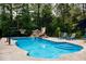Beautiful pool featuring a slide, waterfall, lounge area, and basketball hoop for outdoor fun and recreation at 46 Lakes Edge Ln, Pittsboro, NC 27312