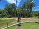 Peaceful backyard bordered by a black fence and lush trees at 502 Yeowell Dr, Chapel Hill, NC 27514